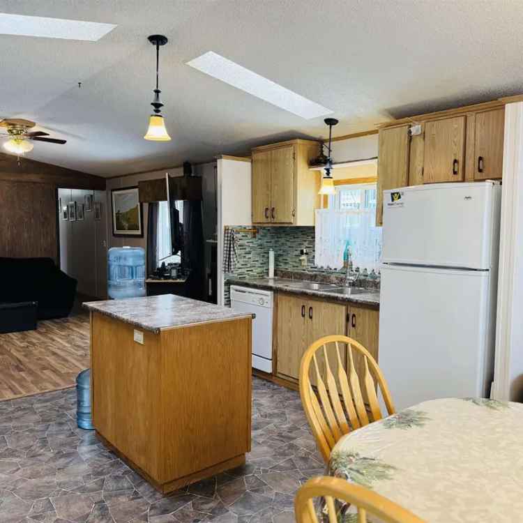 Affordable 2-Bedroom Manufactured Home with Large Deck and Shed