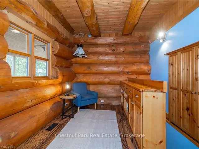 Grand Log Home with Expansive Windows and Covered Porch