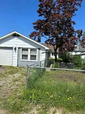 Invest in Queen Street Corridor Property with Huge Lot and Detached Garage