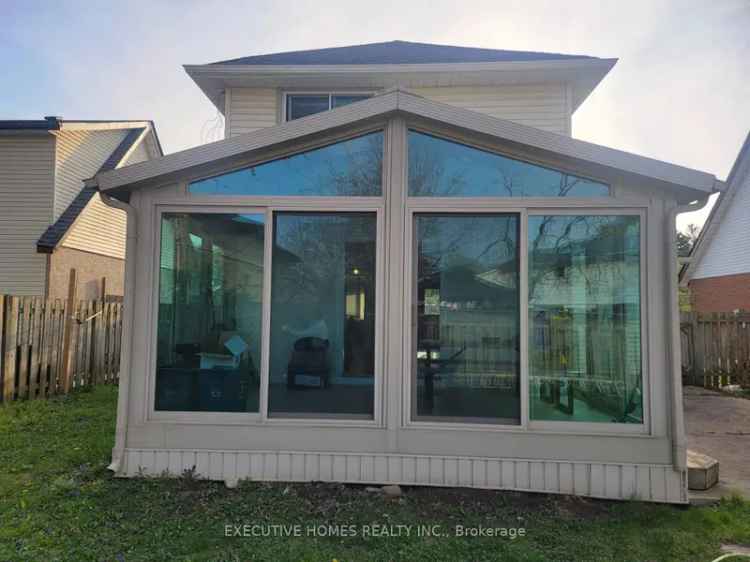 2-Storey Preston Home All Season Sunroom Stamped Concrete Patio
