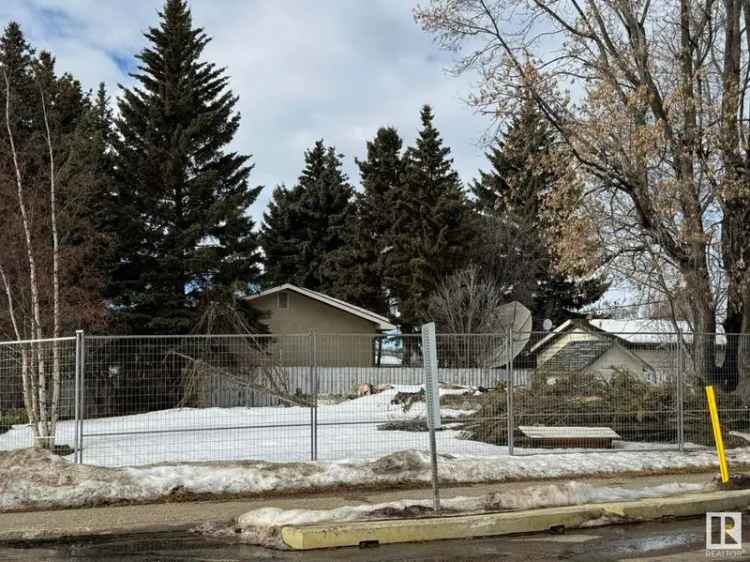 Buy vacant lot with double detached garage for sale