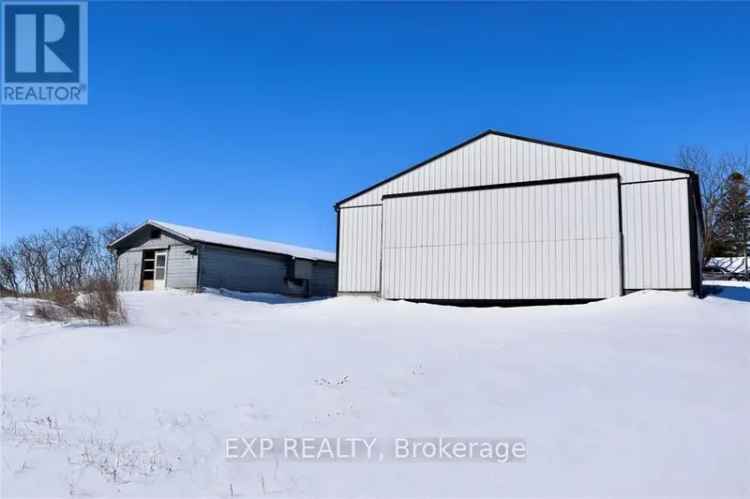 Buy Farm Land in a Picturesque Setting with Workshop and Storage Buildings