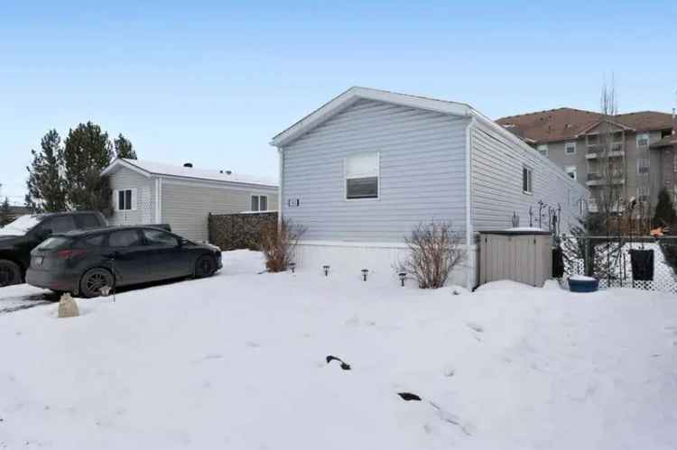 3-Bedroom Home in Okotoks Village with Ensuite and Fenced Yard