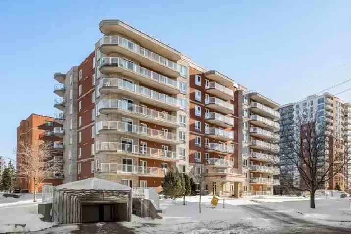 Buy condo in Anjou with large open living space and wrap around balcony