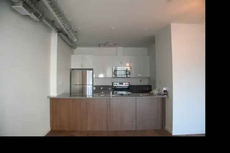 Rent Loft Style Unit with Balcony in Quiet Building Near Amenities