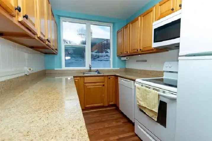 Buy Condo in West End with Stylish Kitchen and Bright Living Room