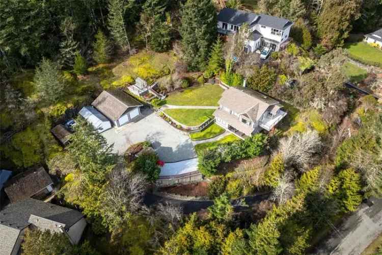 Buy custom home with detached shop in Sooke surrounding trees