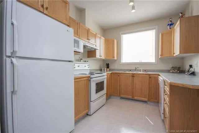 Buy Corner Unit in Red Deer Overlooking Forest Reserve with Balcony