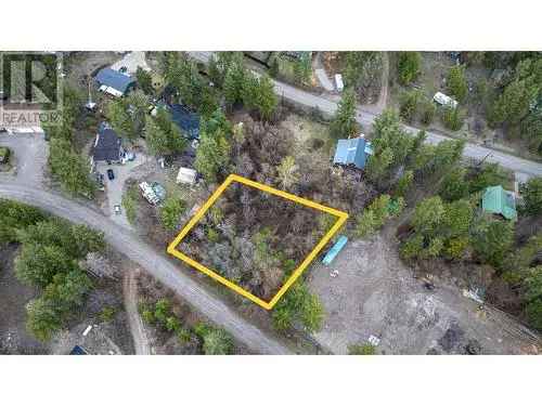 Vacant land for sale in Kelowna with mature trees and proximity to Okanagan Lake